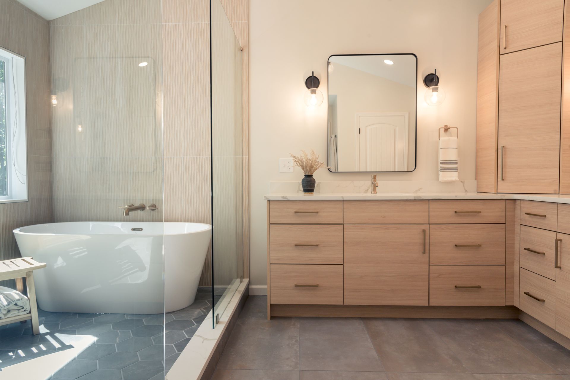 Modern bathroom with freestanding tub, wooden vanity, mirror, and shower in neutral tones