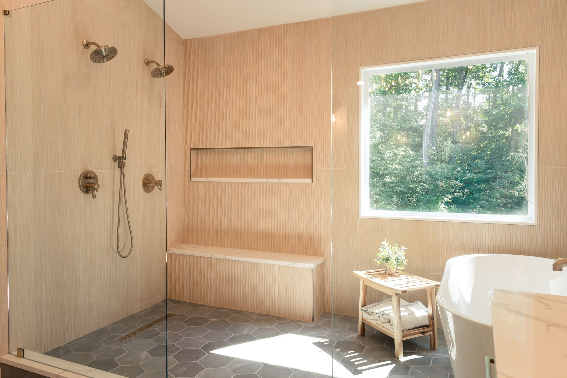 Minimalist spa bathroom with wood walls, shower, built-in bench, and large window overlooking greenery