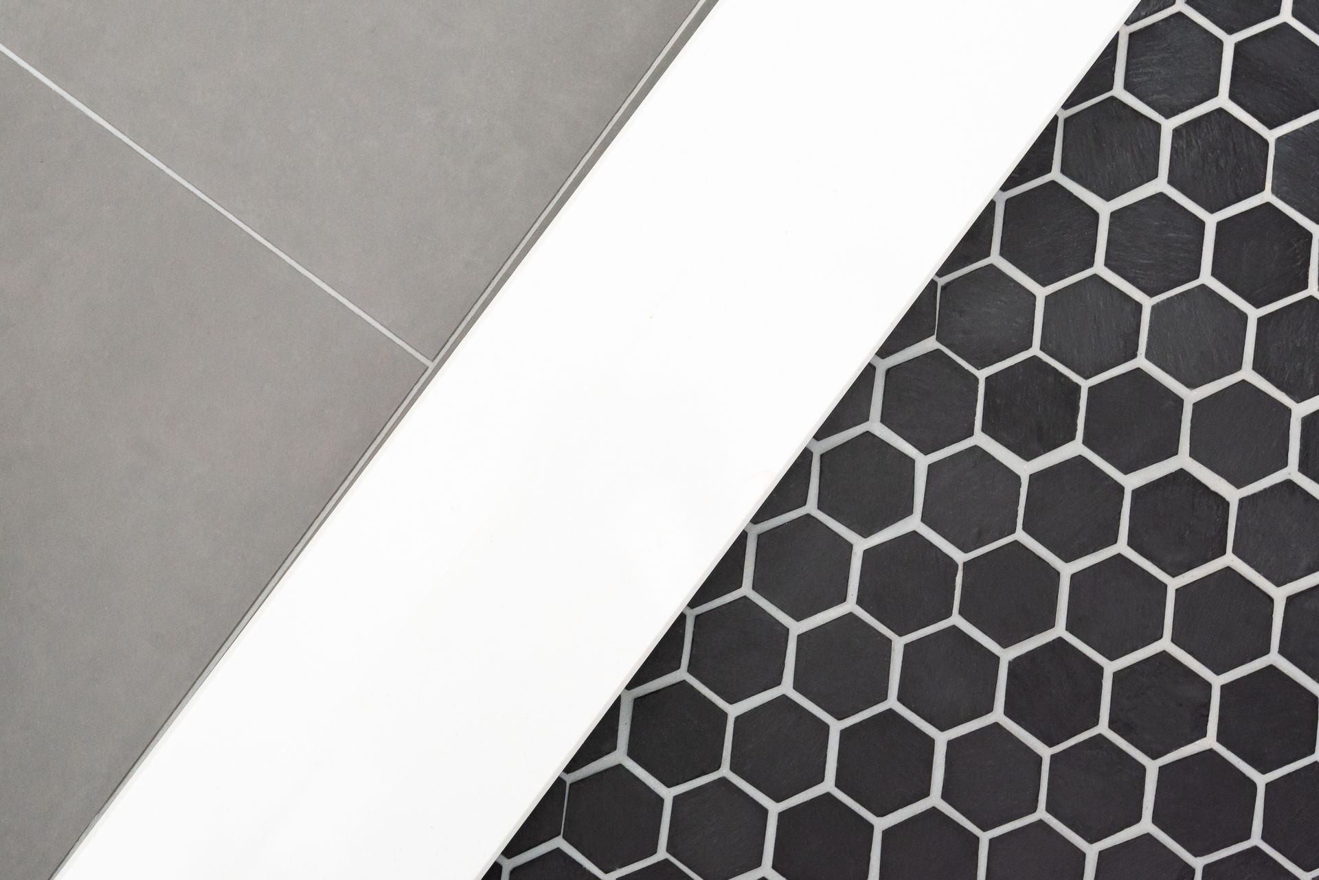 Diagonal white strip between gray panel and black hexagon-patterned surface