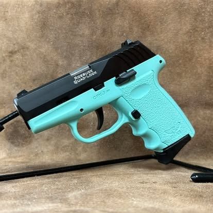 Teal handgun with black top, against a brown backdrop.