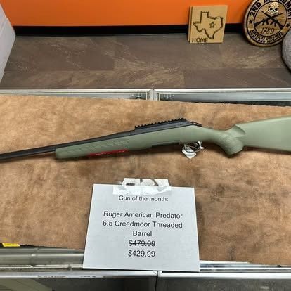 Ruger American Predator rifle on display with a price tag. Green stock and barrel.