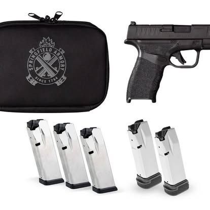 Black Springfield Armory handgun with a case and multiple magazines.