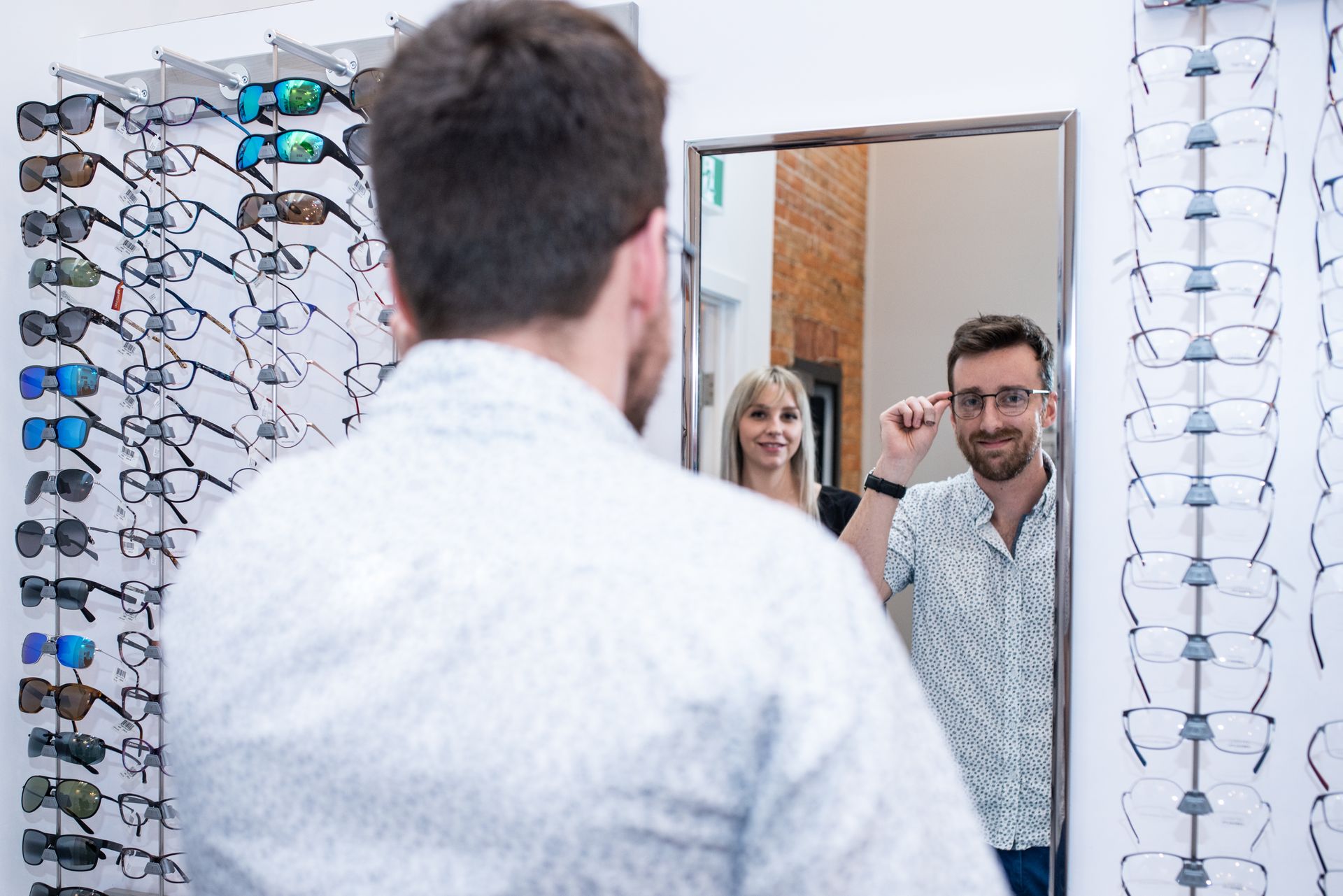 man choosing eye glasses