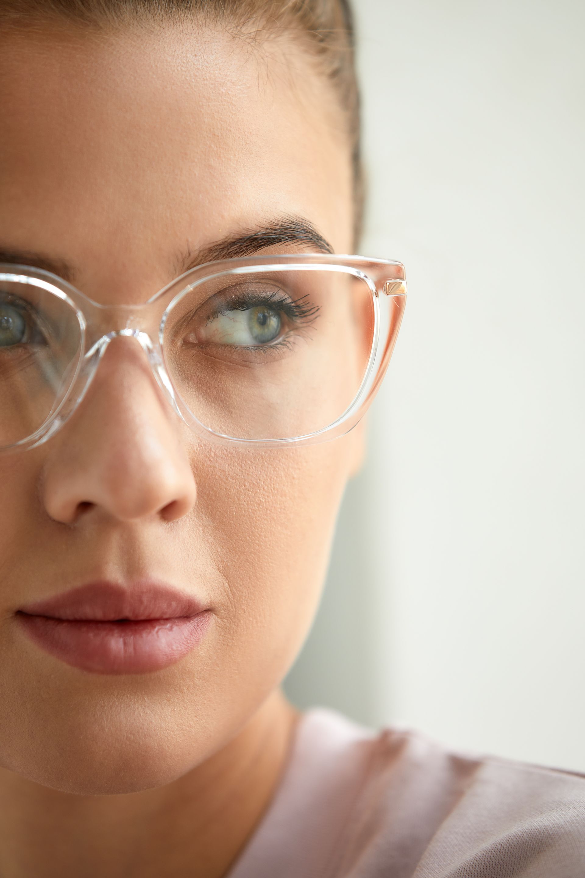 close up of young smiling woman with glasses