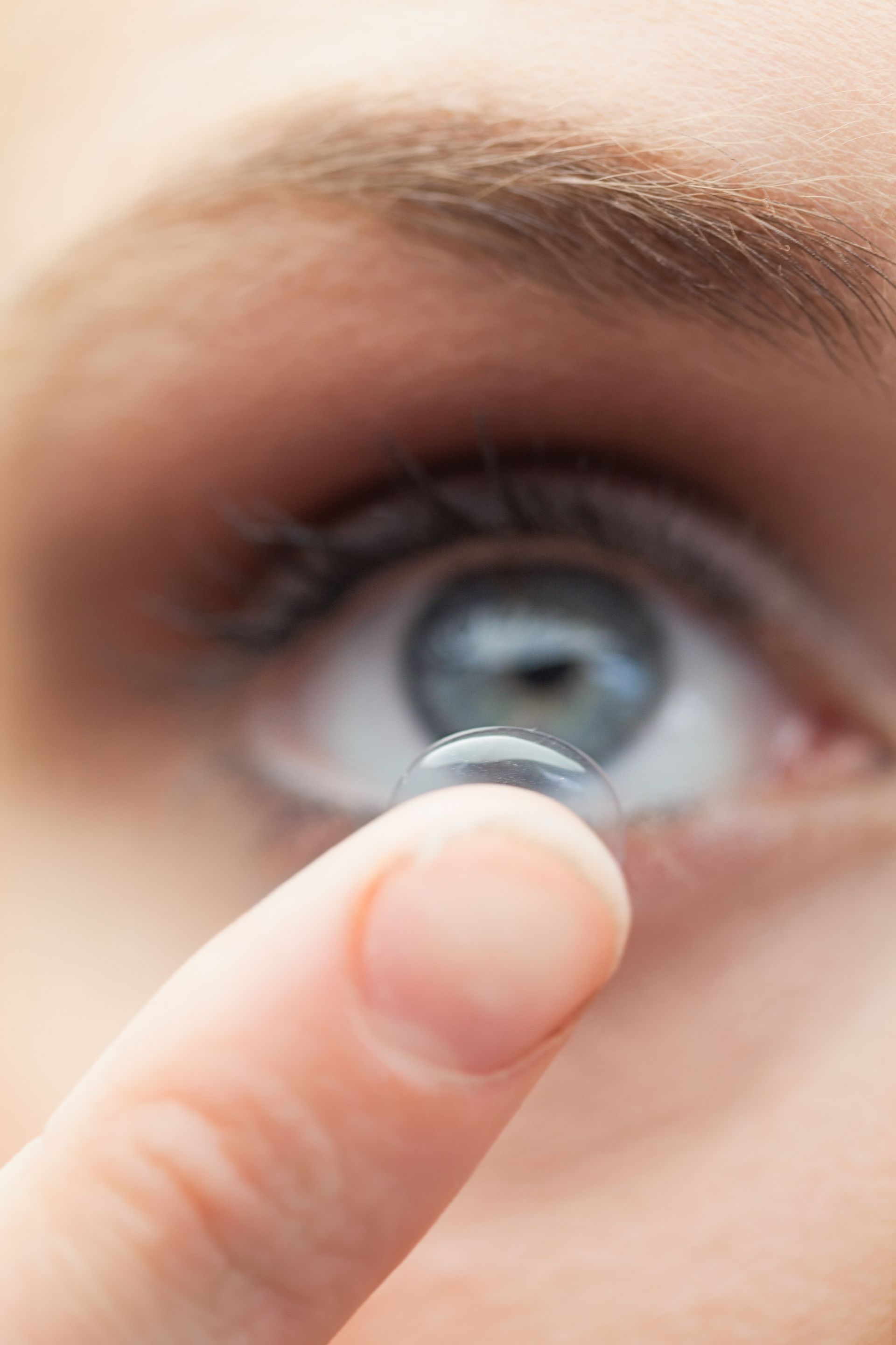 close up of contact lens going into eye