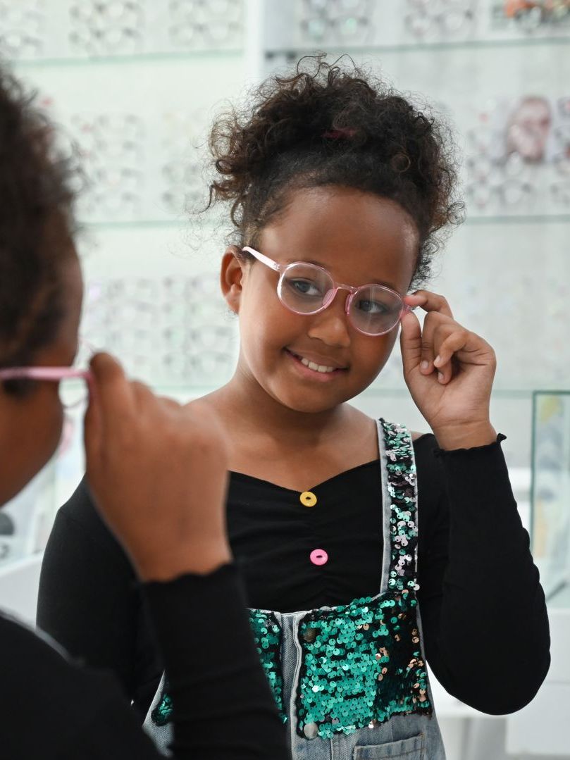 child testing out new glasses