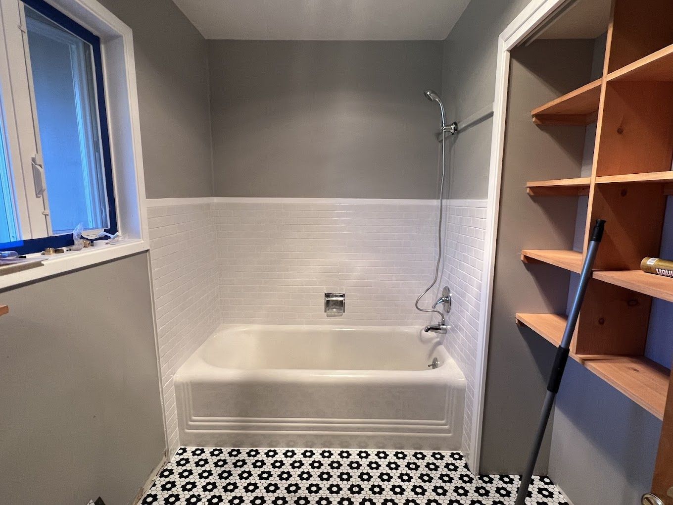 A bathroom with a bathtub and a shower.