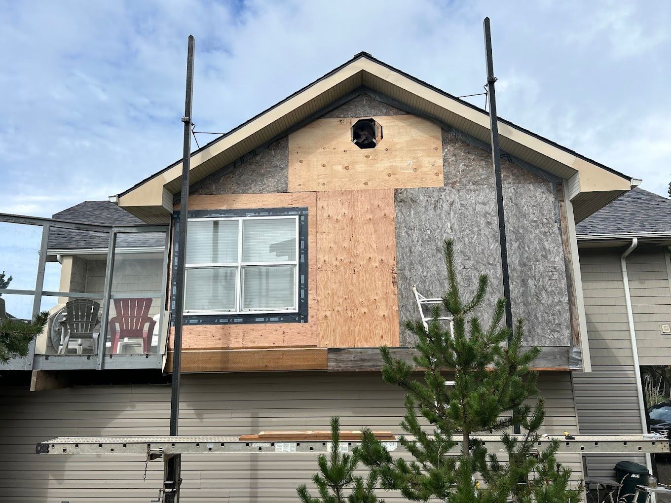 A house with a window and a ladder on the side of it.