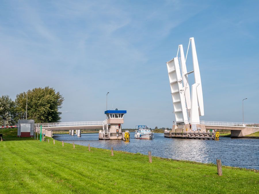 A bridge over a river with a boat in the water.