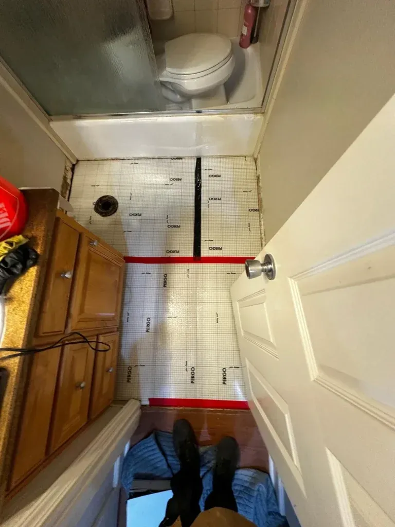 A bathroom with a toilet , sink , and bathtub.