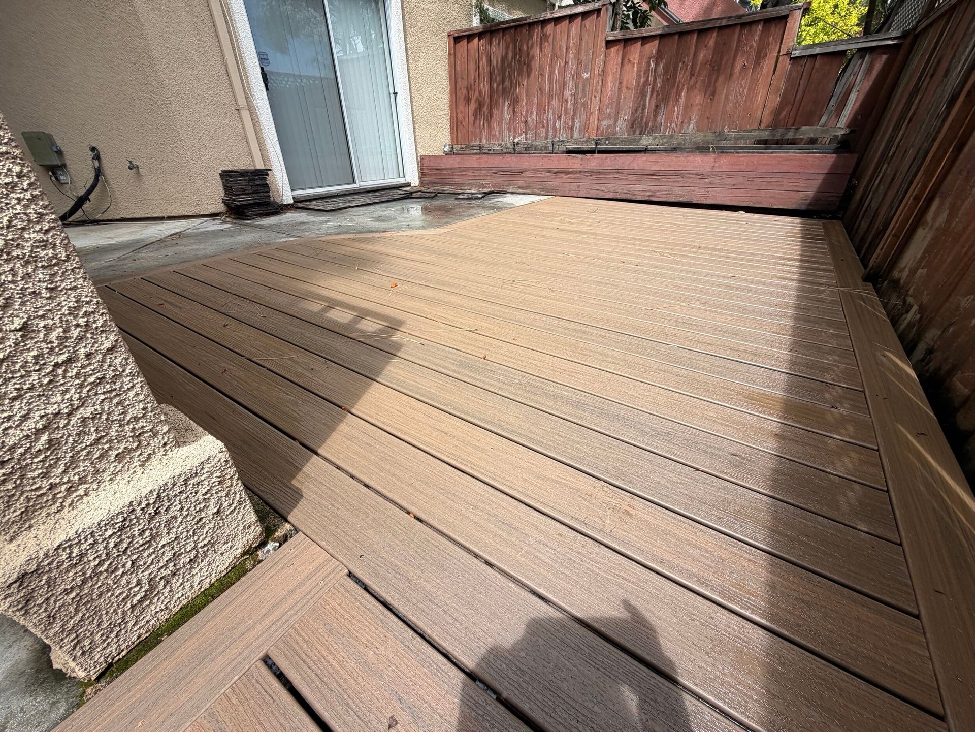 Deck renovation project featuring composite decking installation, upgraded stair system, reinforced structure, and modern outdoor finishes. Exterior remodel completed by Dream Build Services, specializing in deck construction, deck replacement, outdoor living spaces, and residential home improvements in the Bay Area.