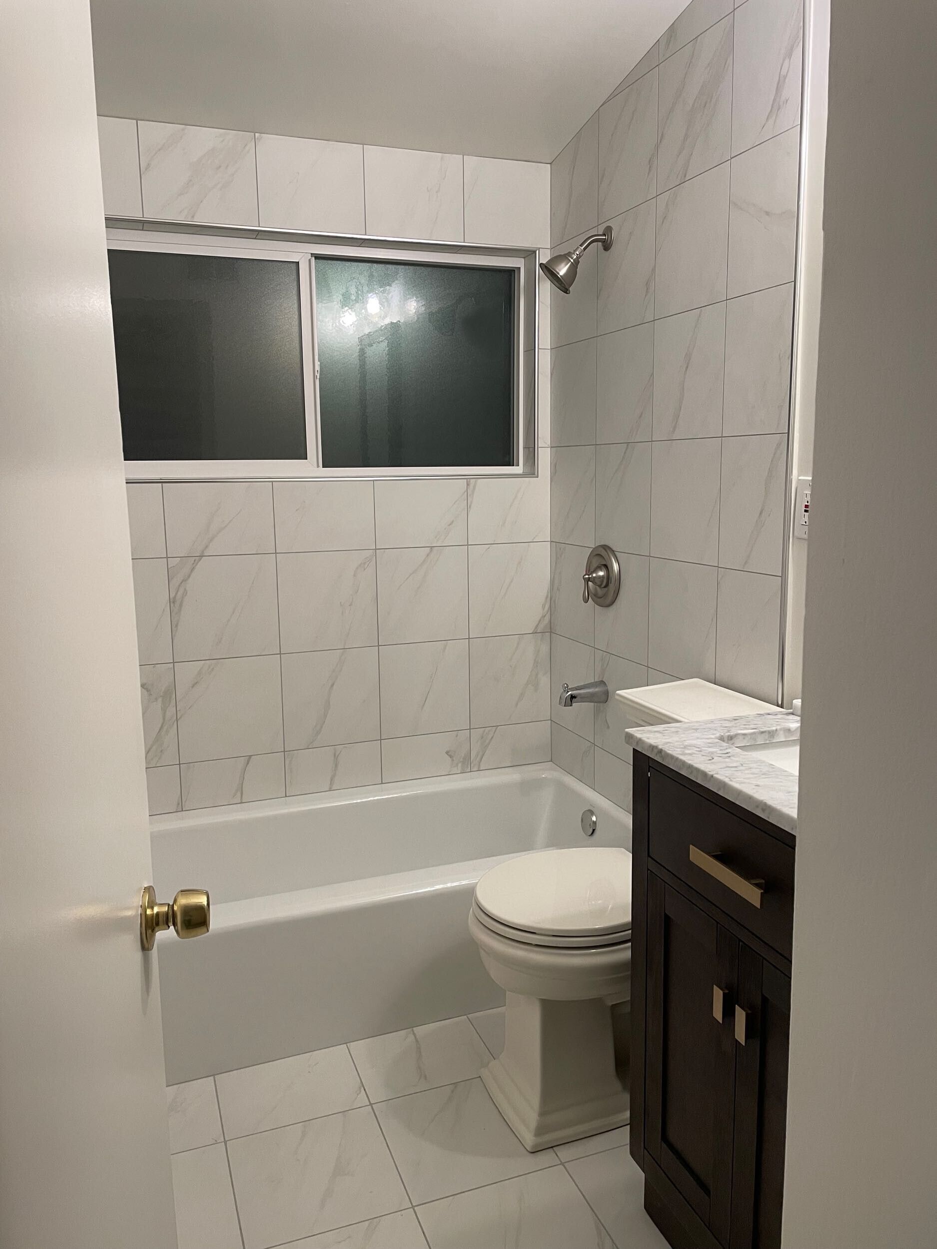 This bathroom remodel by Dream Build Services showcases a complete transformation from an outdated design to a modern, elegant space. The renovation included new marble-look wall and floor tiles, a sleek vanity with upgraded hardware, energy-efficient lighting, and modern plumbing fixtures. The result is a brighter, cleaner, and more functional bathroom that blends comfort and contemporary style. Located in the Bay Area, Dream Build Services specializes in bathroom remodels, home renovations, and functional design improvements.