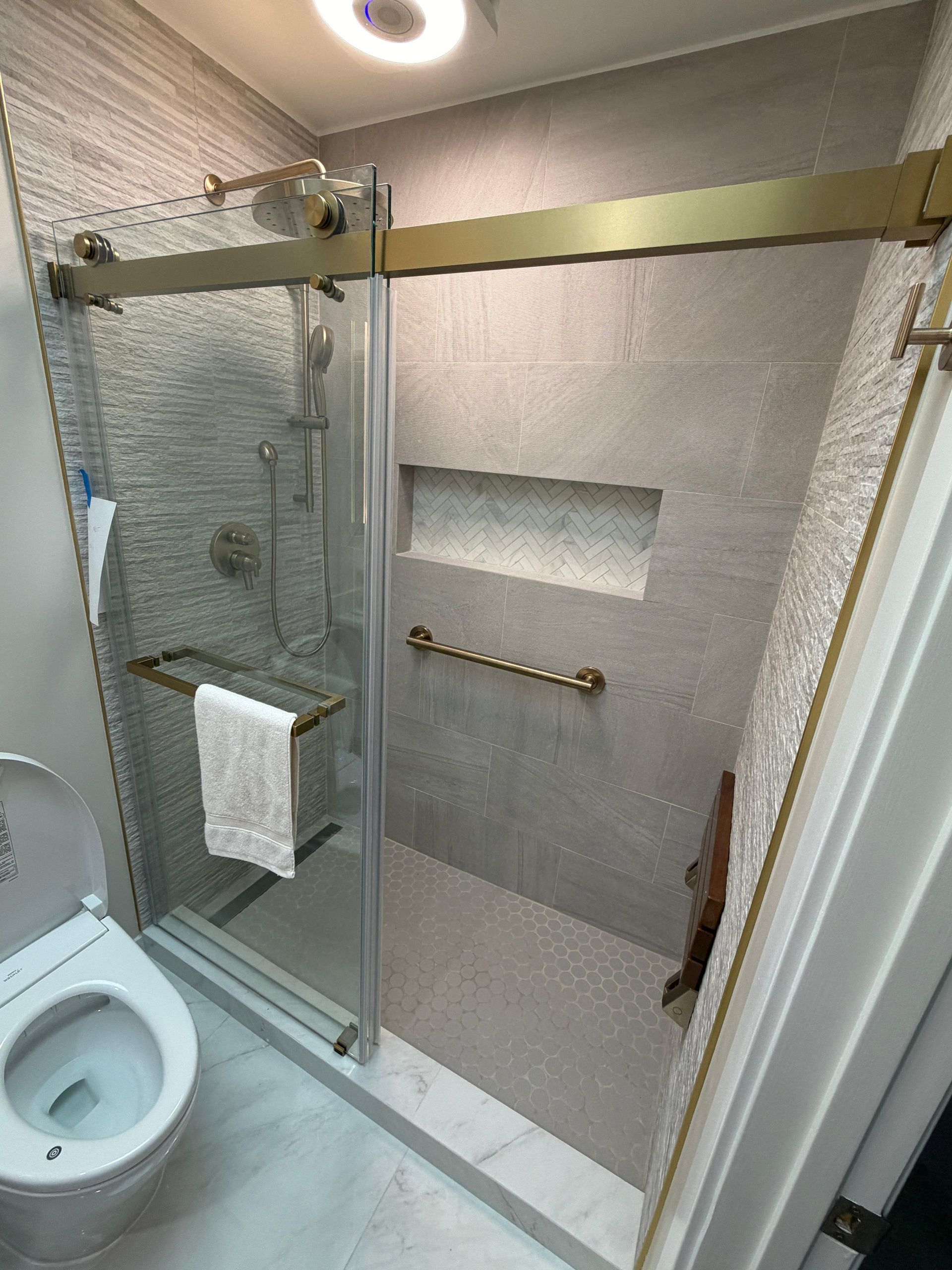 Complete bathroom remodeling transformation featuring a modern walk-in shower with frameless glass enclosure, large-format porcelain wall tile, custom shower niche, luxury rainfall shower system, floating-style vanity with quartz countertop, LED medicine cabinet, brushed gold fixtures, premium porcelain flooring, contemporary lighting, and upgraded plumbing fixtures. This full bathroom renovation replaced an outdated bathtub with a spacious walk-in shower, maximizing functionality, accessibility, and modern design while increasing home value.
Dream Build Services specializes in custom bathroom remodeling, bathroom renovations, shower conversions, tub-to-shower replacements, vanity installations, tile installation, flooring, lighting upgrades, plumbing fixtures, and complete home remodeling throughout the San Francisco Bay Area.