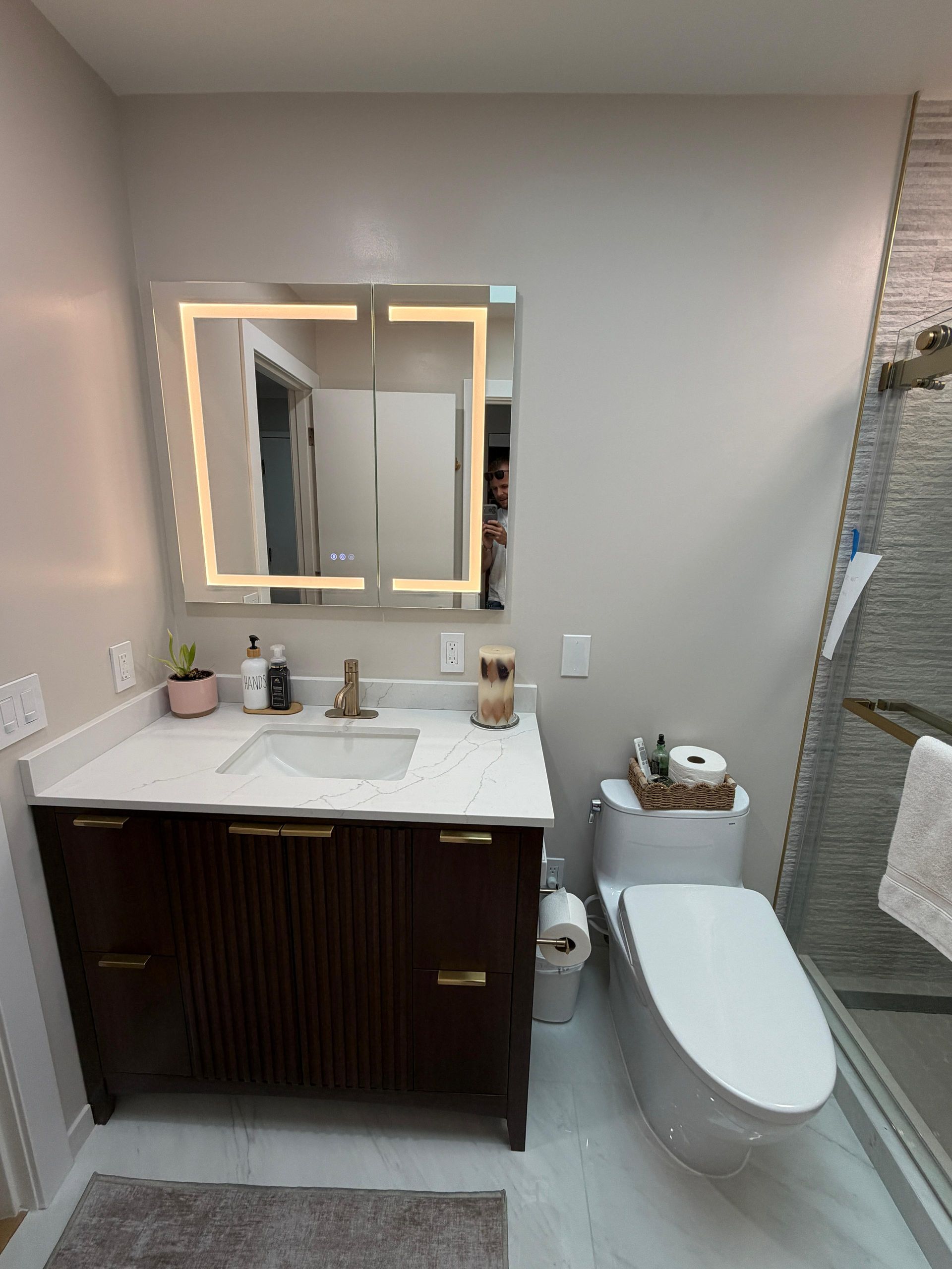 Complete bathroom remodeling transformation featuring a modern walk-in shower with frameless glass enclosure, large-format porcelain wall tile, custom shower niche, luxury rainfall shower system, floating-style vanity with quartz countertop, LED medicine cabinet, brushed gold fixtures, premium porcelain flooring, contemporary lighting, and upgraded plumbing fixtures. This full bathroom renovation replaced an outdated bathtub with a spacious walk-in shower, maximizing functionality, accessibility, and modern design while increasing home value.
Dream Build Services specializes in custom bathroom remodeling, bathroom renovations, shower conversions, tub-to-shower replacements, vanity installations, tile installation, flooring, lighting upgrades, plumbing fixtures, and complete home remodeling throughout the San Francisco Bay Area.