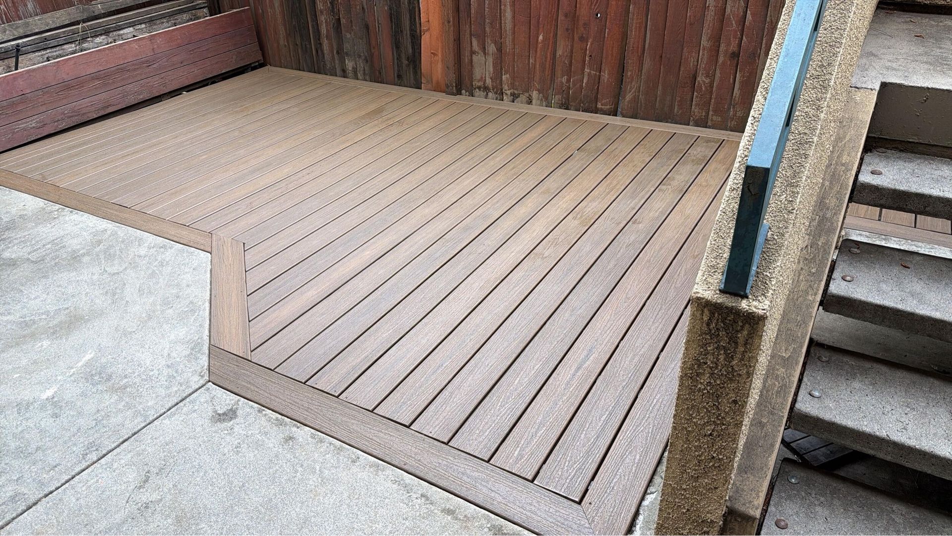 Deck renovation project featuring composite decking installation, upgraded stair system, reinforced structure, and modern outdoor finishes. Exterior remodel completed by Dream Build Services, specializing in deck construction, deck replacement, outdoor living spaces, and residential home improvements in the Bay Area.