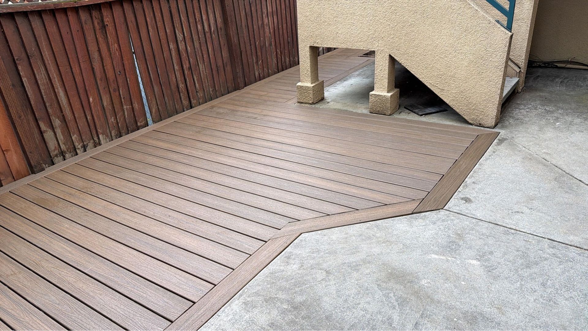 Deck renovation project featuring composite decking installation, upgraded stair system, reinforced structure, and modern outdoor finishes. Exterior remodel completed by Dream Build Services, specializing in deck construction, deck replacement, outdoor living spaces, and residential home improvements in the Bay Area.