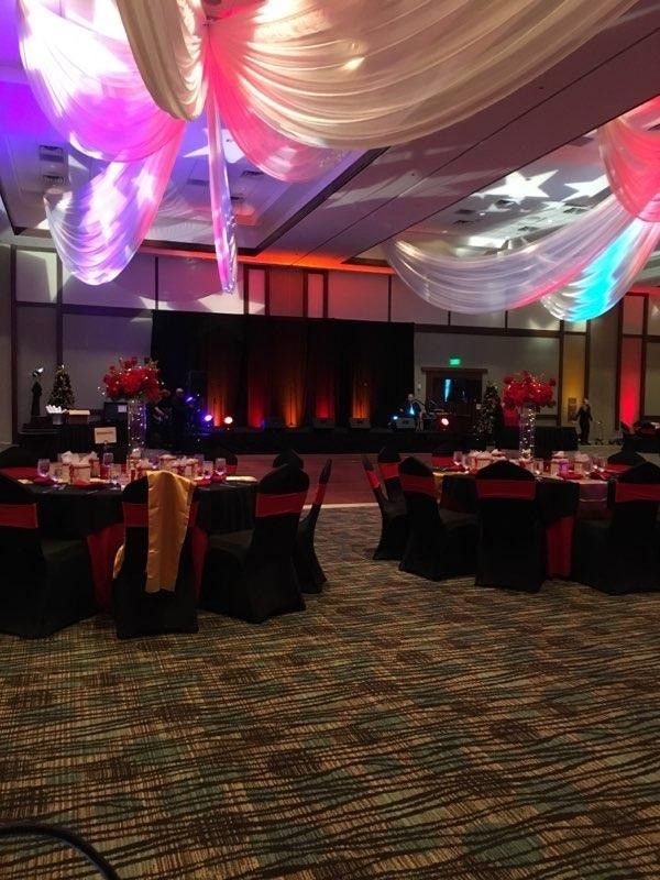 A large room with tables and chairs set up for a party