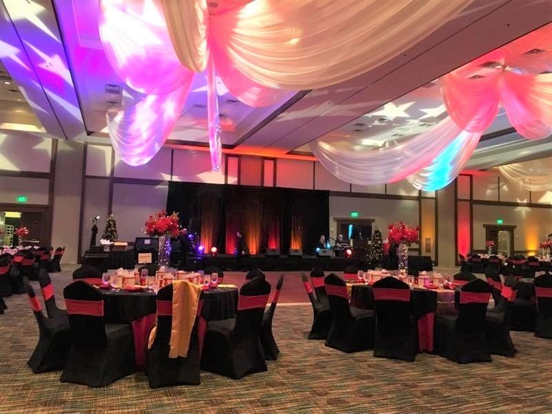 A large room with tables and chairs set up for a party
