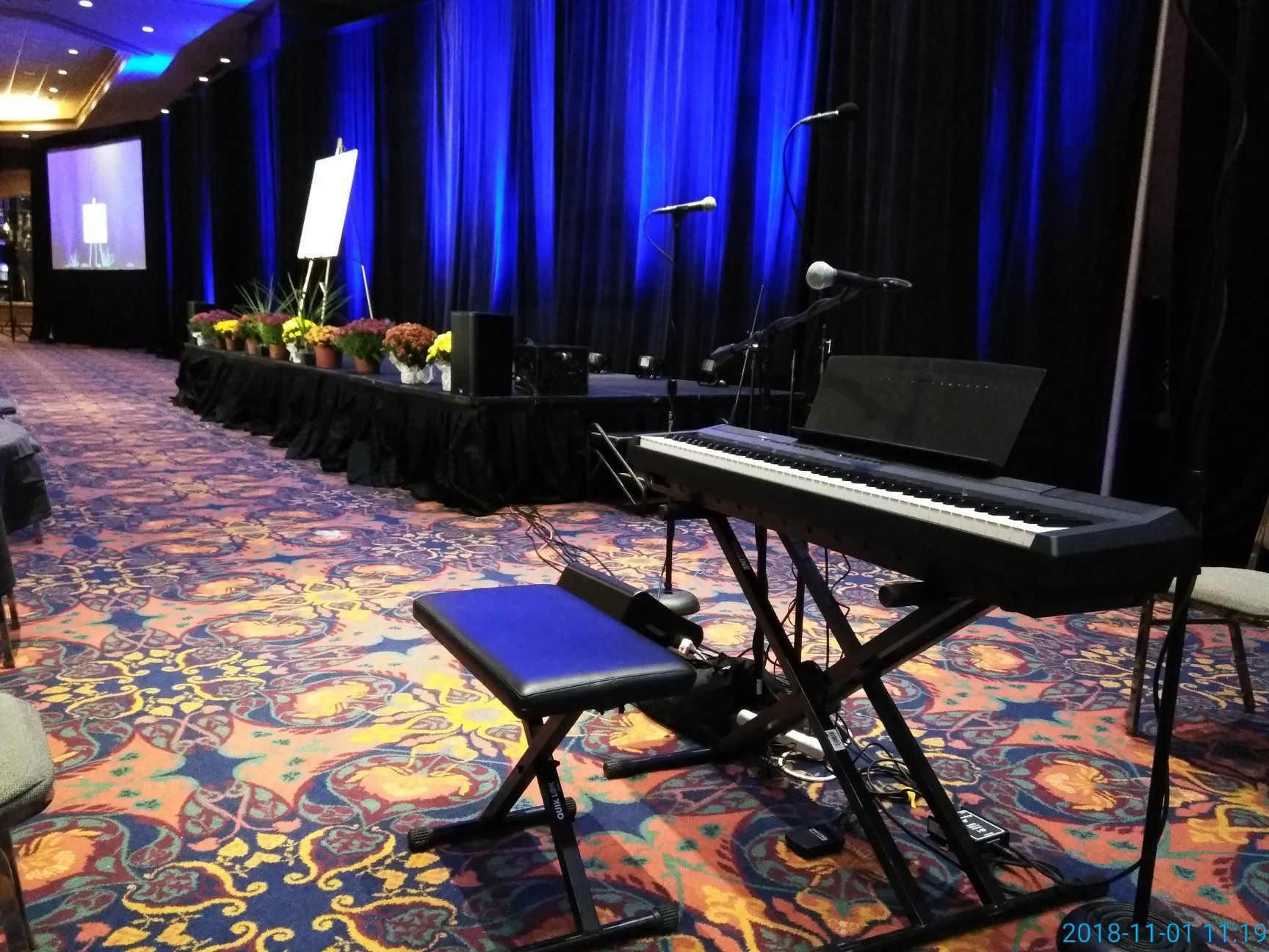 A piano is sitting on a stand in front of a stage