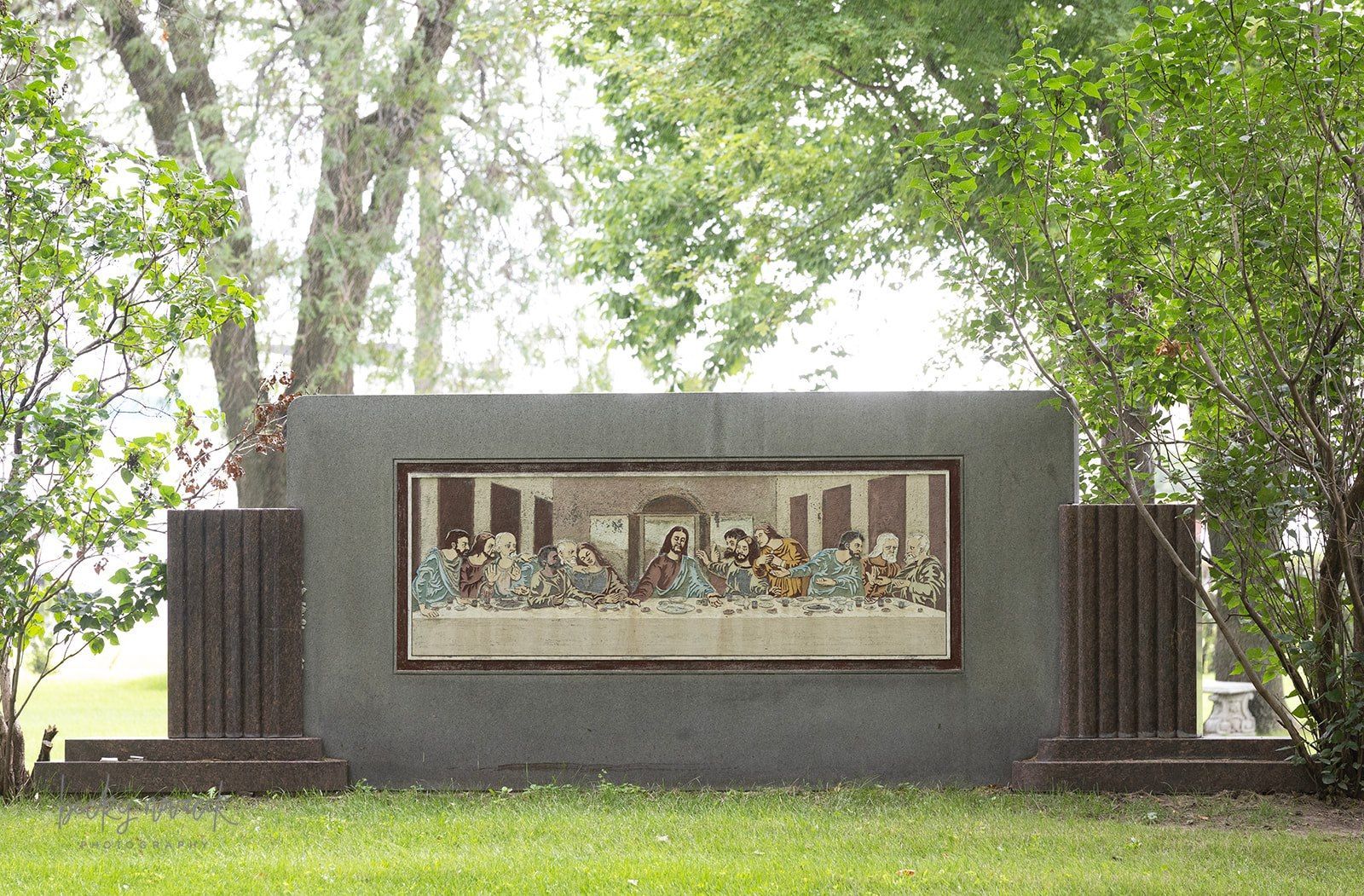 casket being lower into a grave during a memorial service