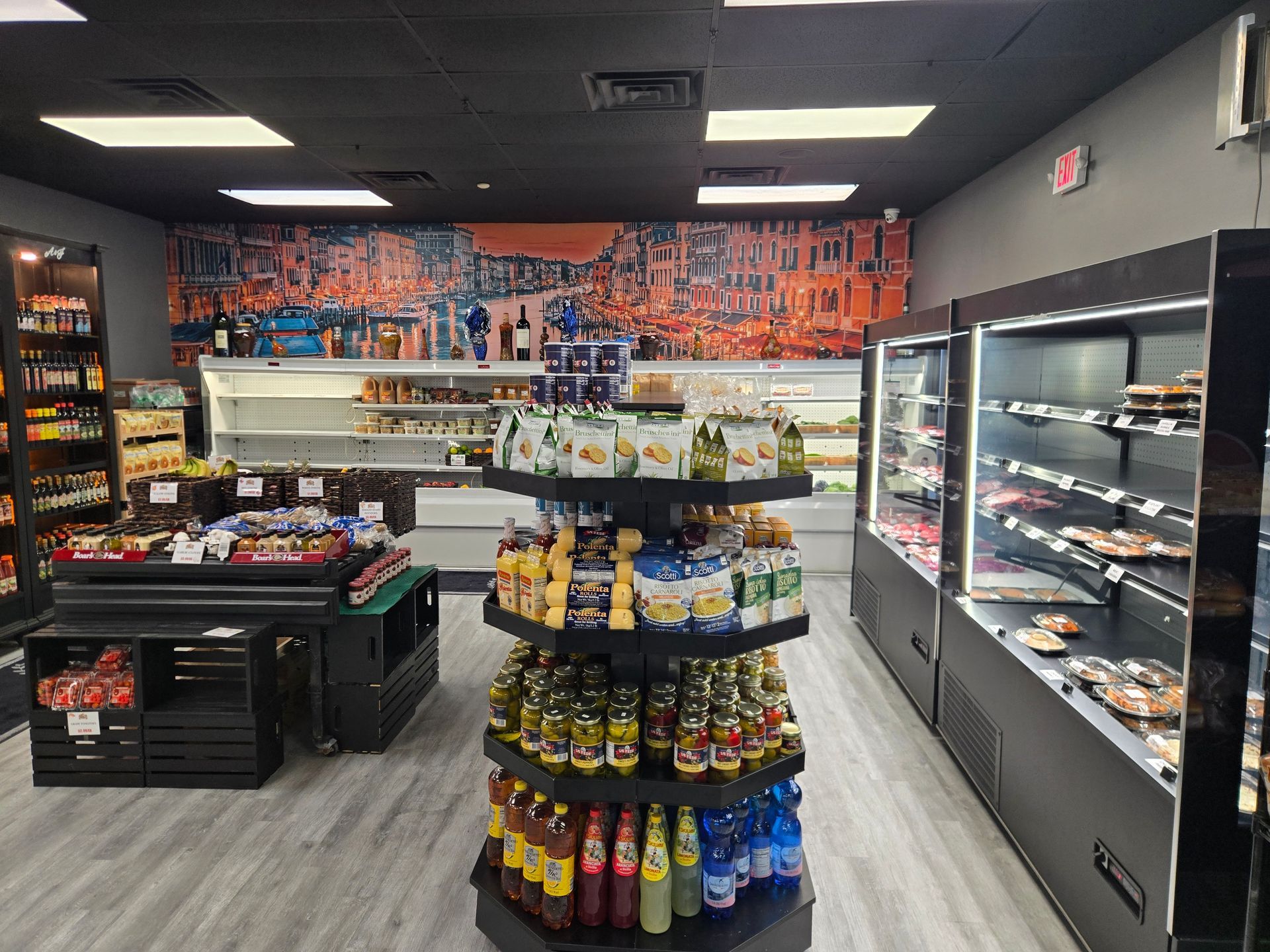 Convenience store aisle with snacks, drinks, and refrigerated shelves under bright lights