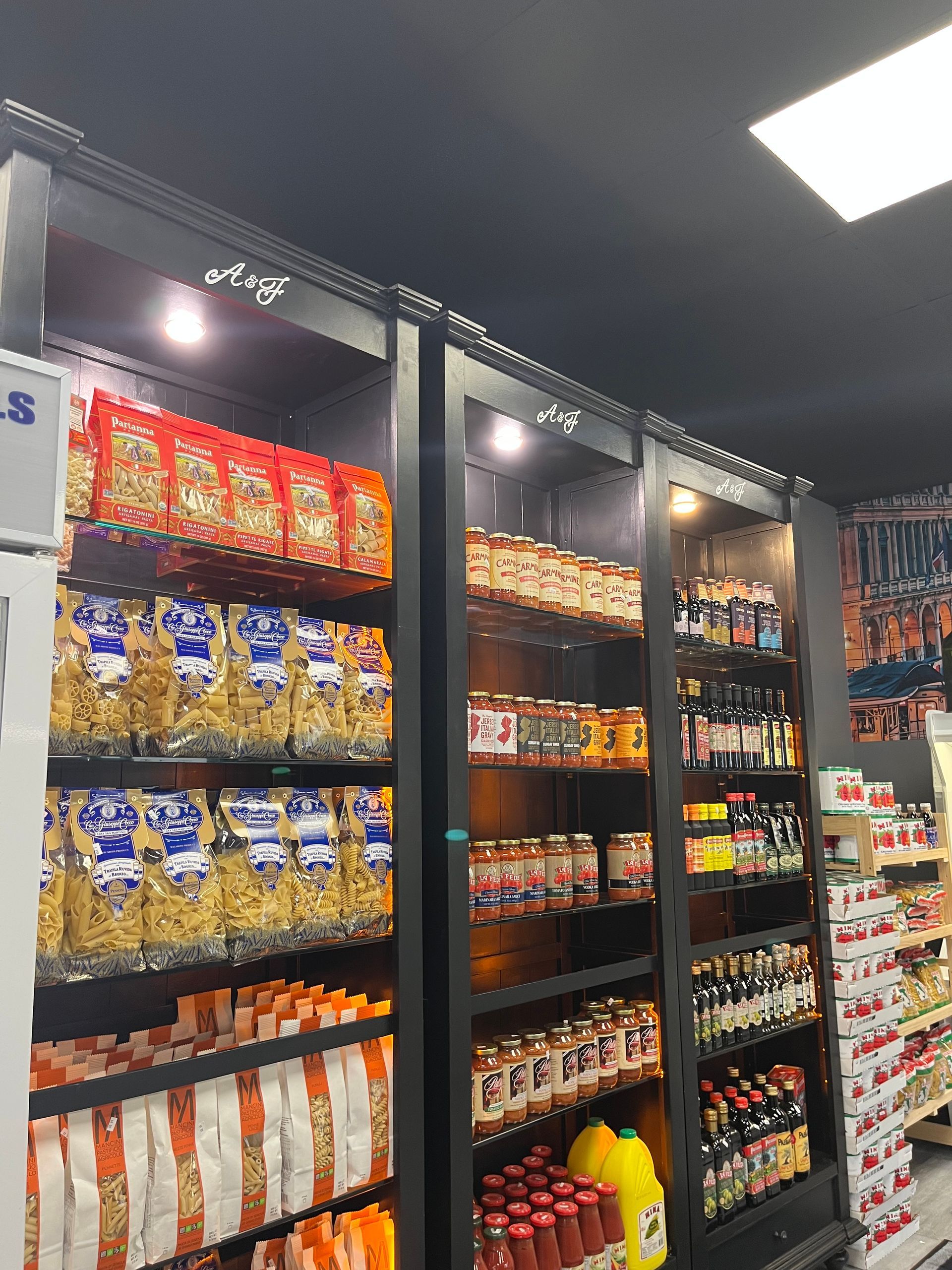 Snack aisle in a store with shelves of chips, candy, and drinks under bright lights