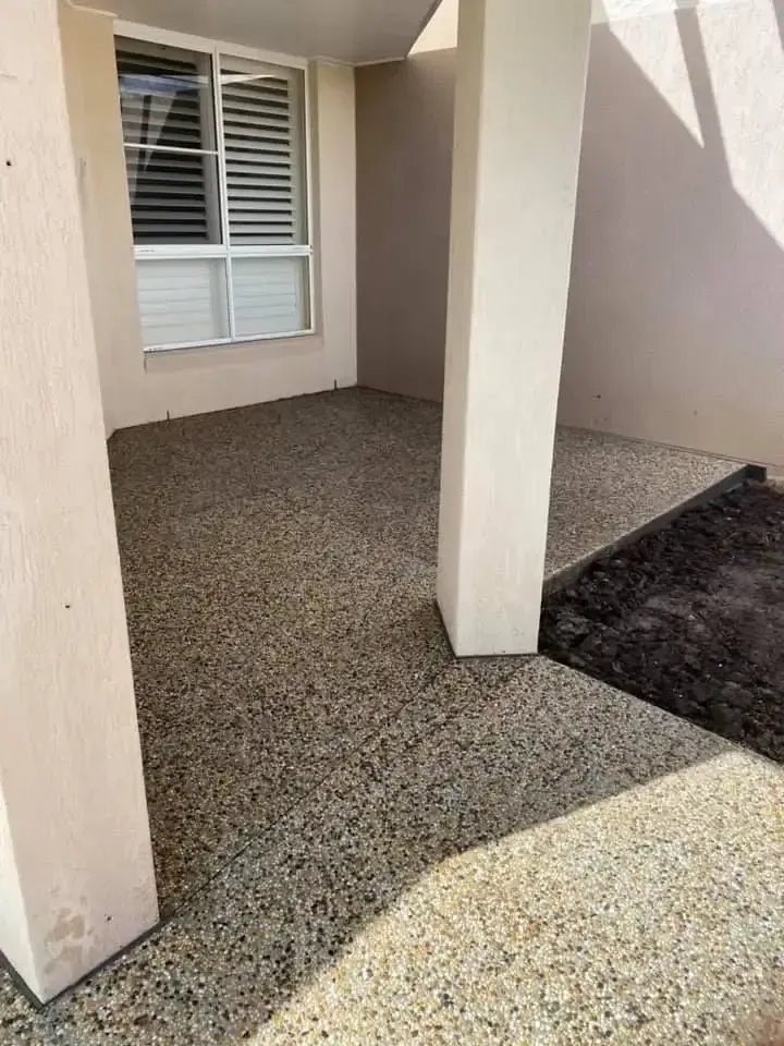A Patio With A Window And Pillars In Front Of A House — Luke Seears Concreting in Port Macquarie, NSW