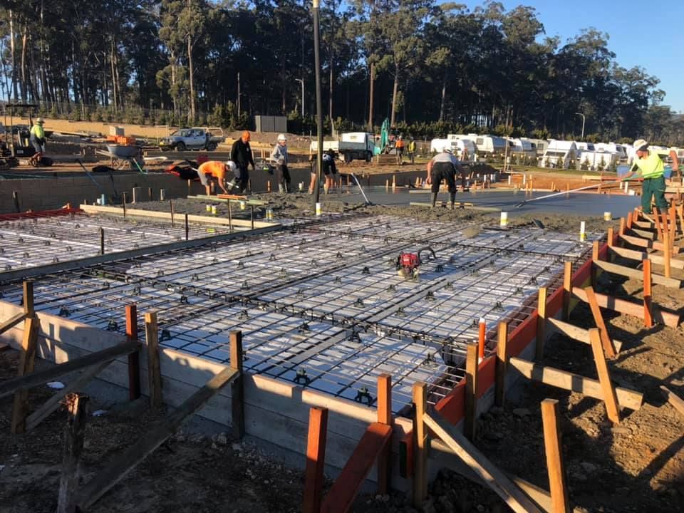A Group Of Construction Workers Are Working On A Concrete Floor — Luke Seears Concreting in Port Macquarie, NSW