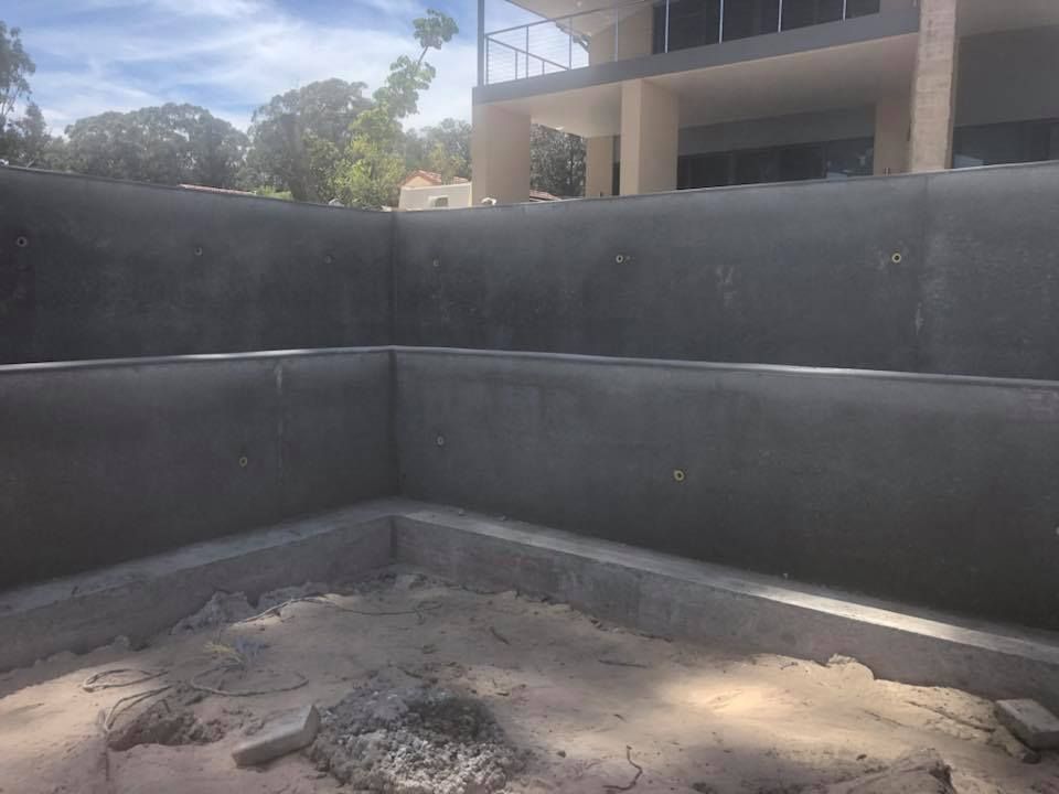 A Large Concrete Wall Is Being Built In Front Of A Building — Luke Seears Concreting in Port Macquarie, NSW