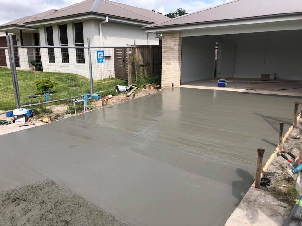 A Concrete Driveway Is Being Built In Front Of A House — Luke Seears Concreting in Port Macquarie, NSW