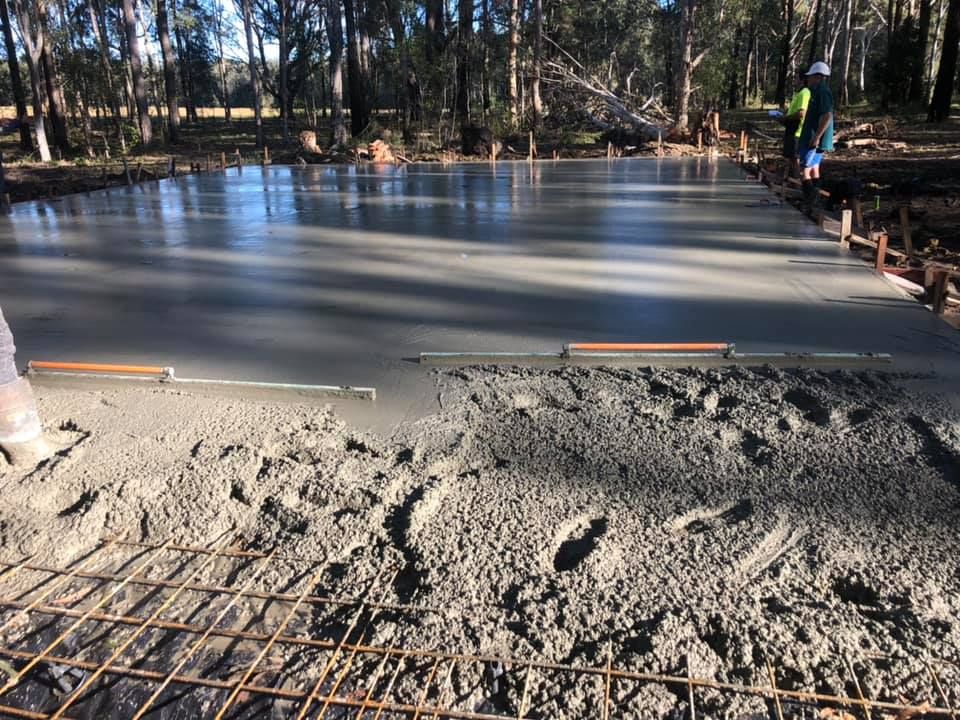 A Concrete Floor Is Being Poured In A Forest — Luke Seears Concreting in Port Macquarie, NSW