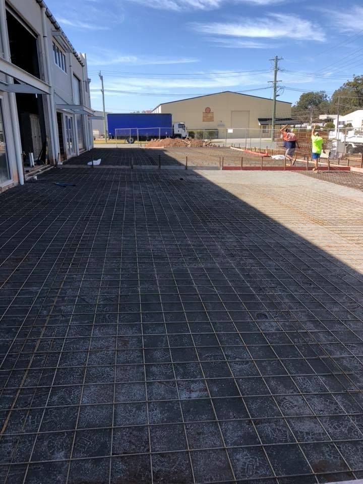 A Concrete Driveway Is Being Built In Front Of A Building — Luke Seears Concreting in Wauchope, NSW