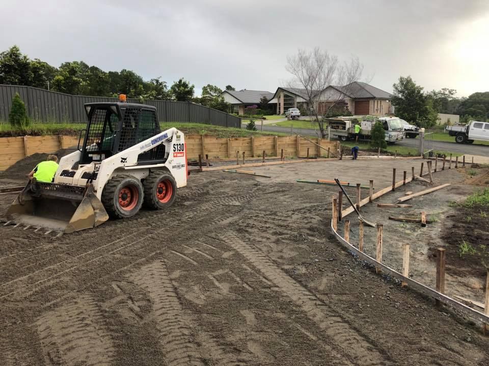 A Bobcat Is Moving Dirt On A Construction Site — Luke Seears Concreting in Wauchope, NSW
