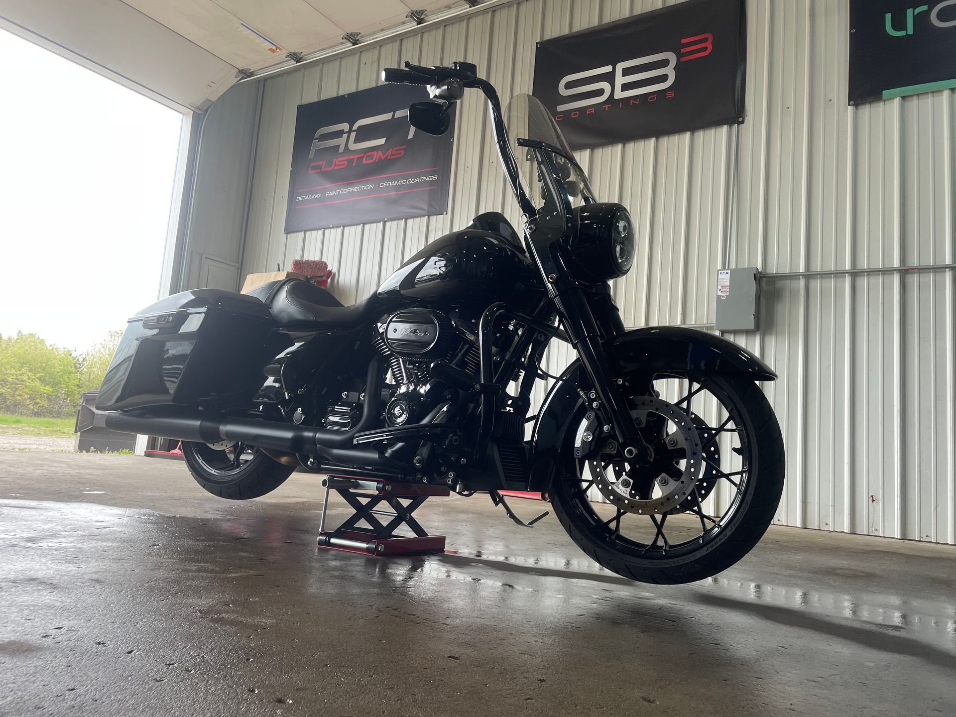 A black harley davidson motorcycle is parked in a garage.