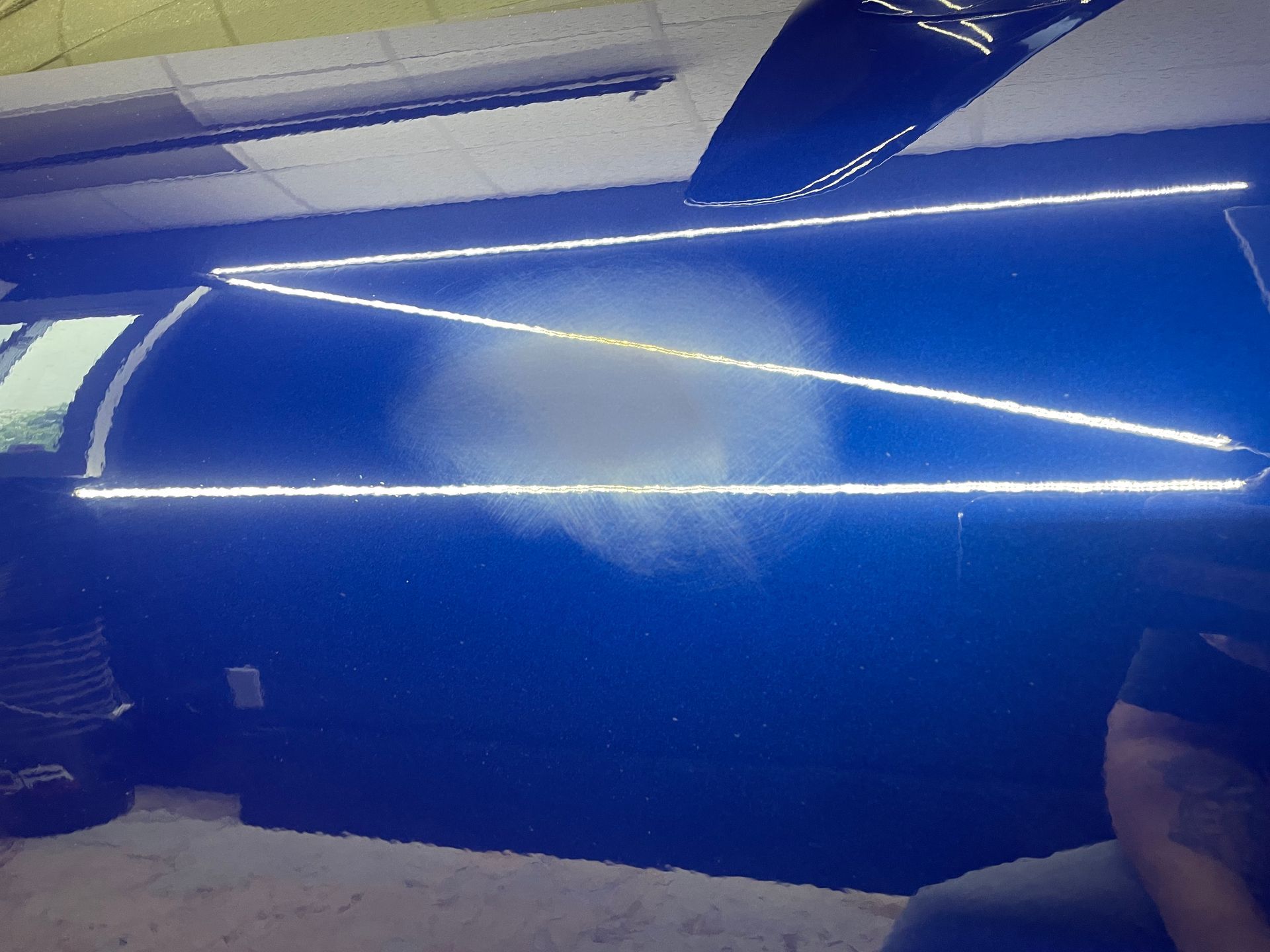 A person is sitting in front of a blue lighted wall