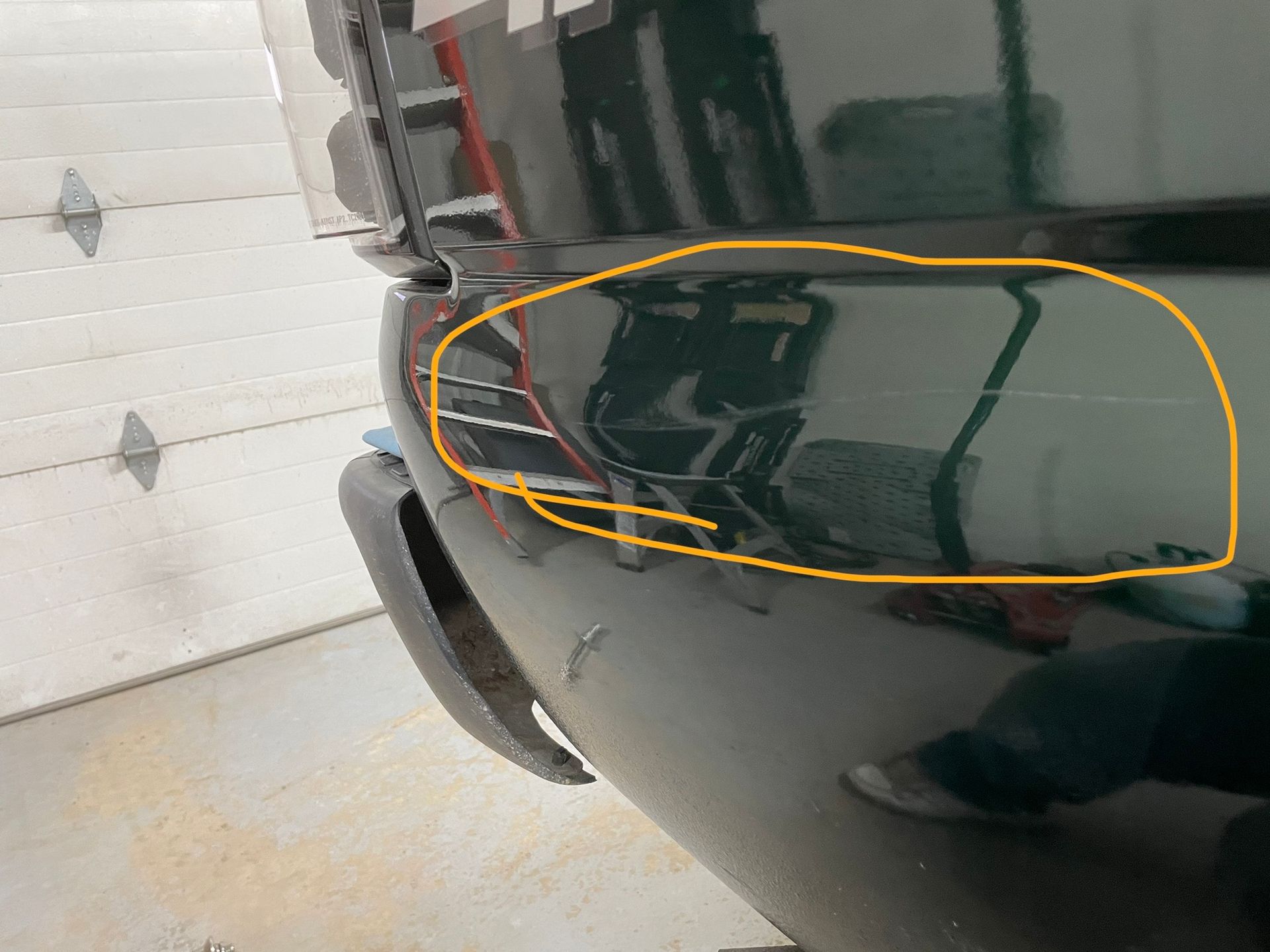 A black car with a yellow circle around it