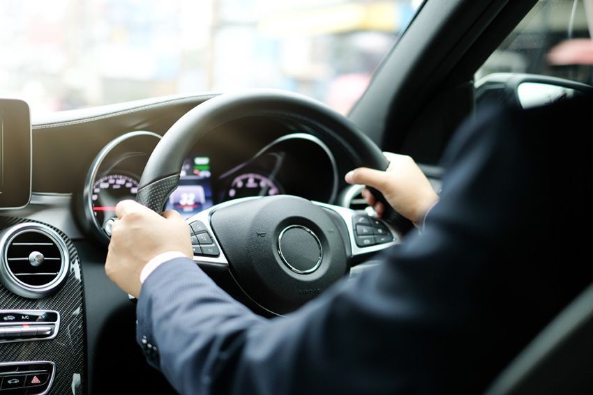 A Man in a Suit is Driving a Car — Toowoomba Lube & Mechanical in Glenvale, QLD