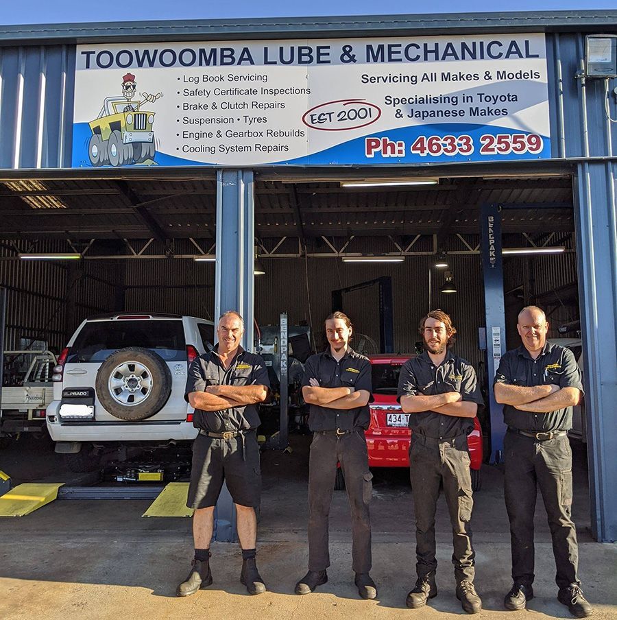A group of men standing in front of a toowoomba lube and mechanical garage — Toowoomba Lube & Mechanical in Glenvale, QLD