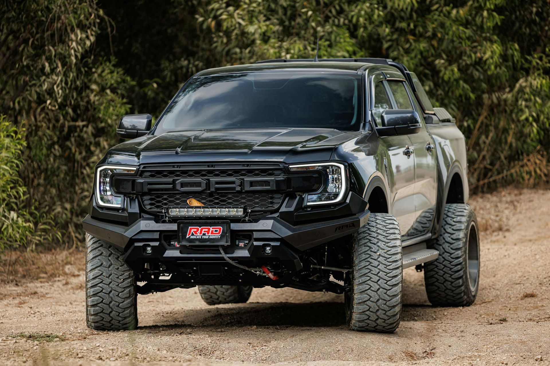 A Black Ford Raptor is Parked on a Dirt Road — Toowoomba Lube & Mechanical in Glenvale, QLD