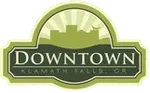 Downtown Klamath Falls, Oregon logo with green arch and building silhouette