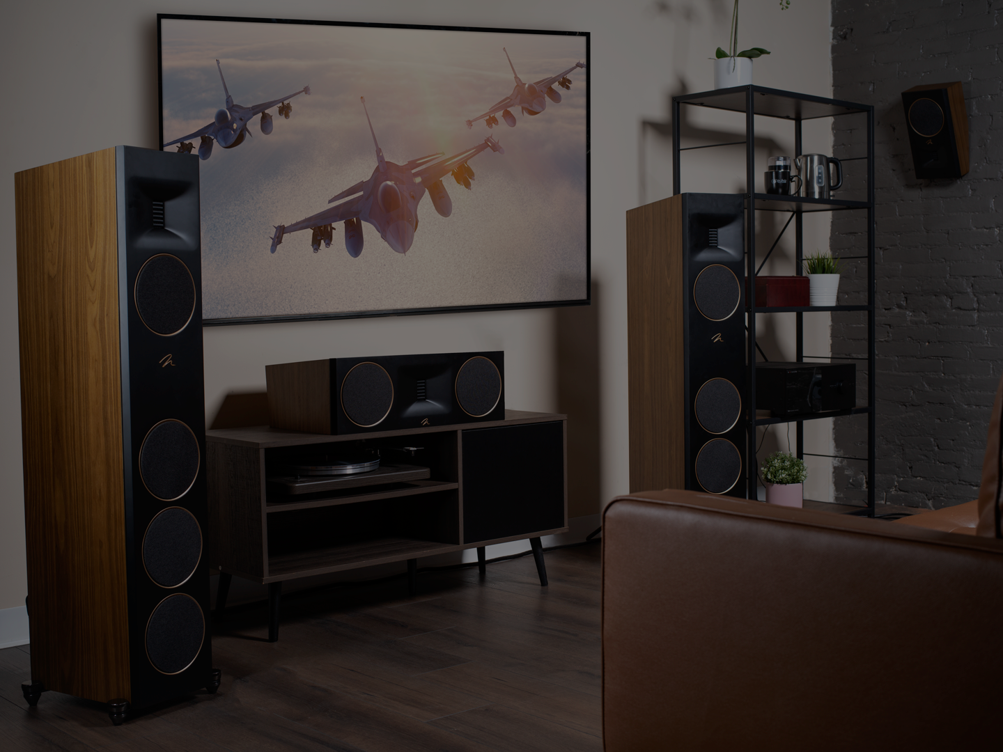 Living room with large speakers, TV cabinet, and a plane artwork on the wall