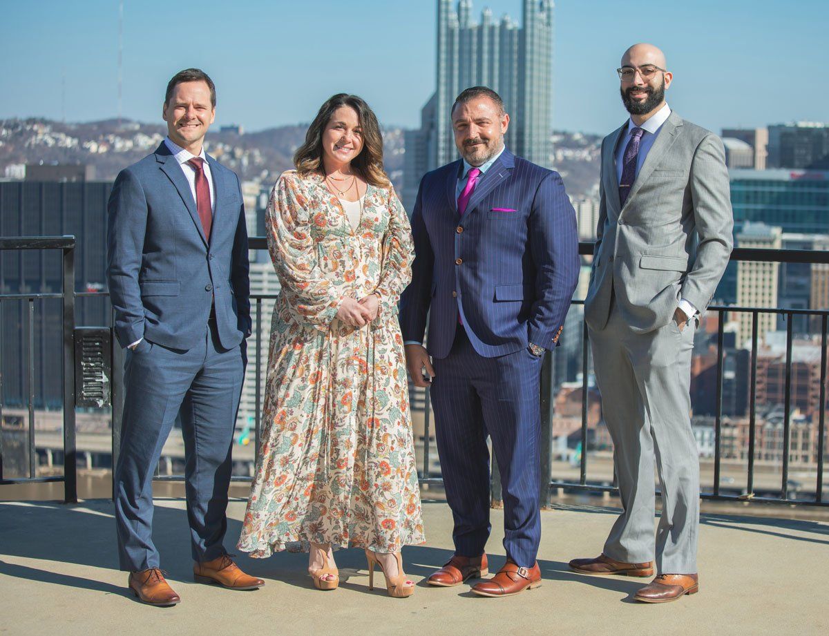A group of people in suits and ties are standing next to each other on a balcony.