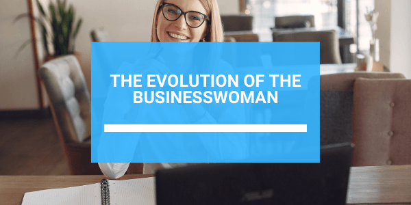 A woman is sitting at a desk in front of a laptop computer.