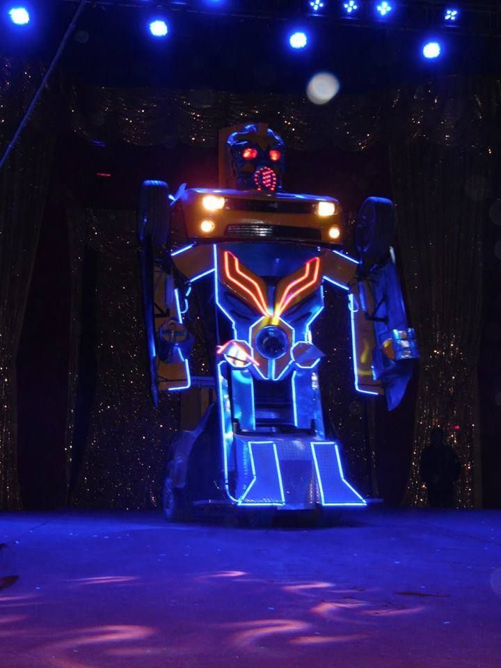A robot that is glowing in the dark on a stage | Arabia Shrine Circus