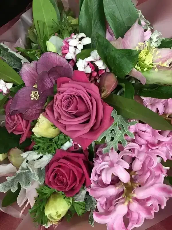 a close up of a bouquet of pink and purple flowers