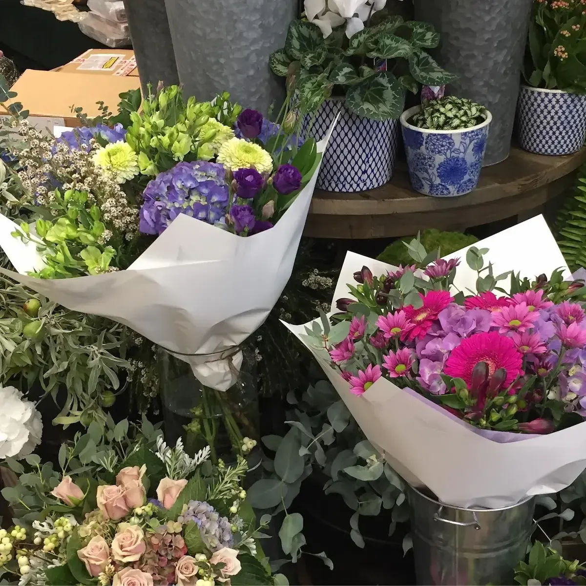 A bunch of flowers are wrapped in white paper