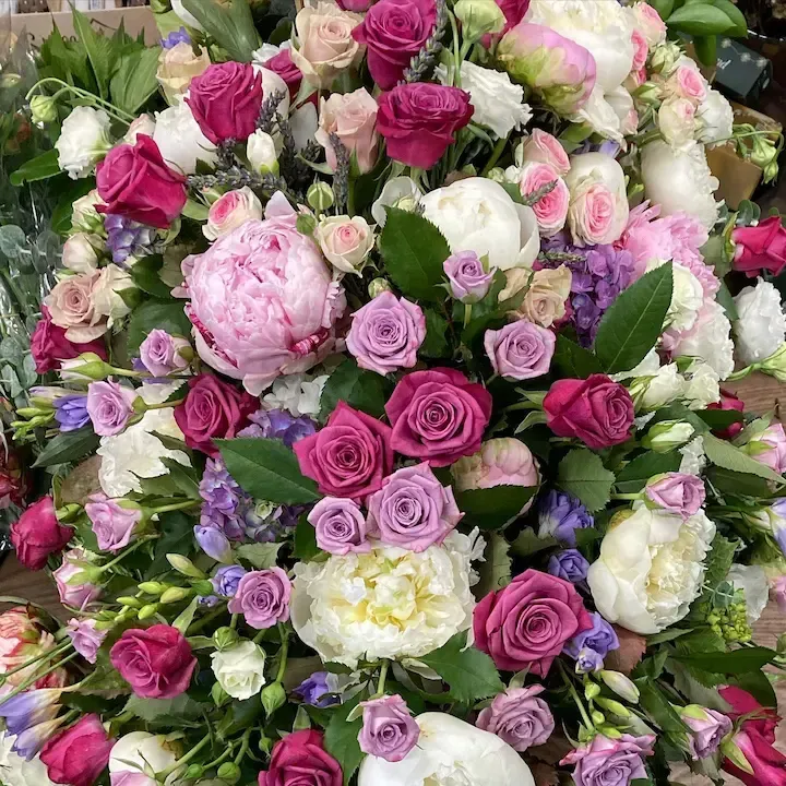 There are many different types of flowers in this arrangement.