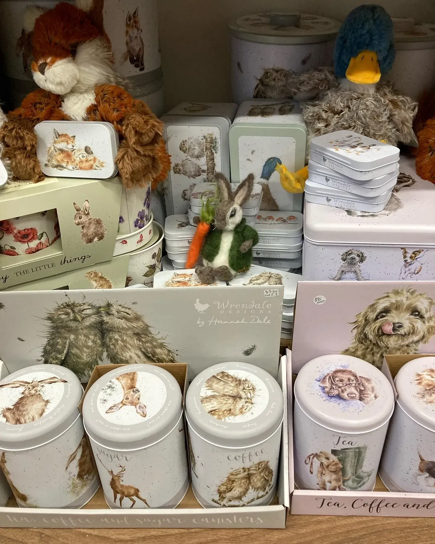 A bunch of cans with animals on them are sitting on a table.
