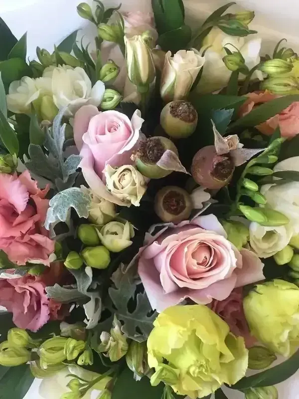 A close up of a bouquet of flowers on a table.