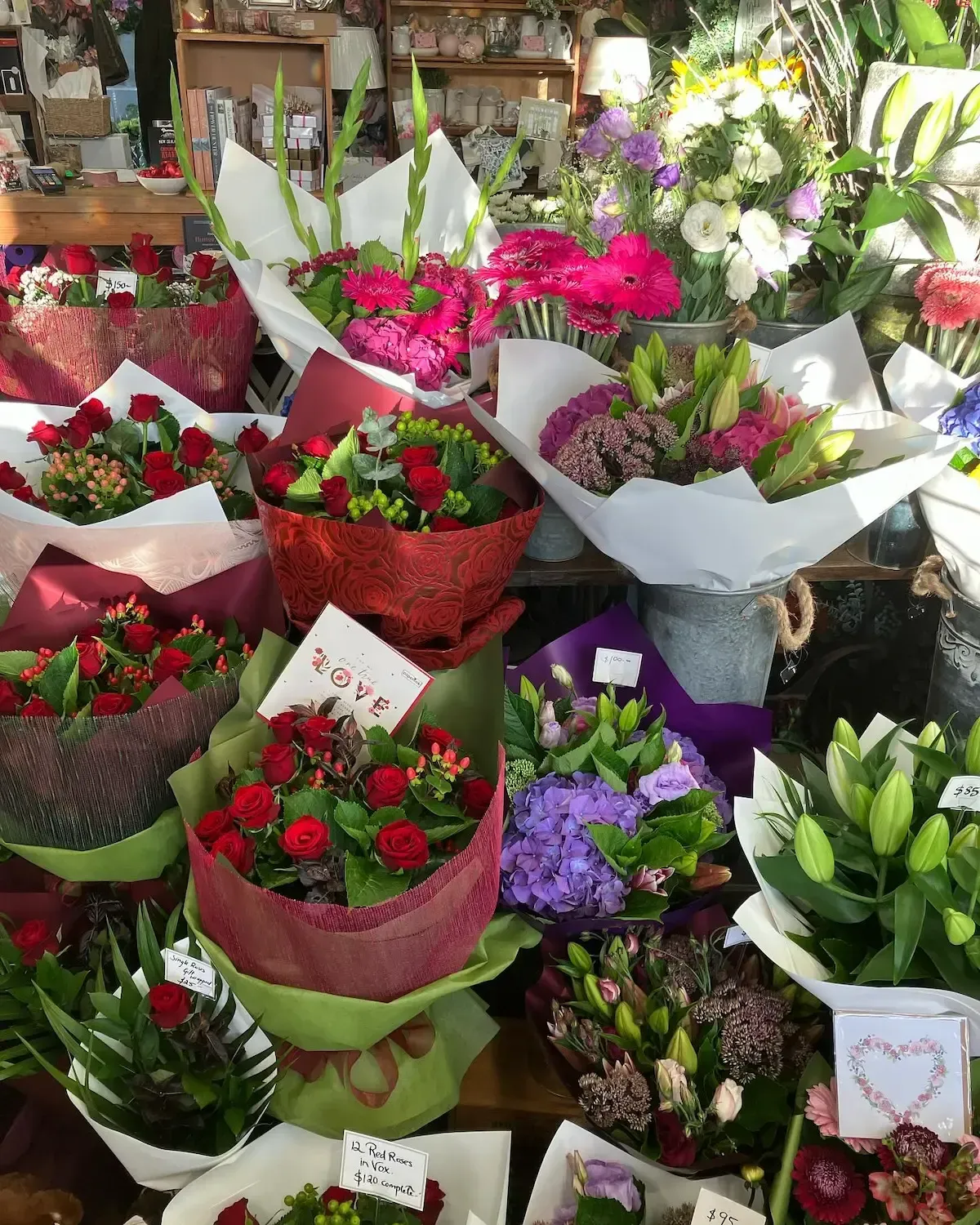 A bunch of flowers on a table with one that says love